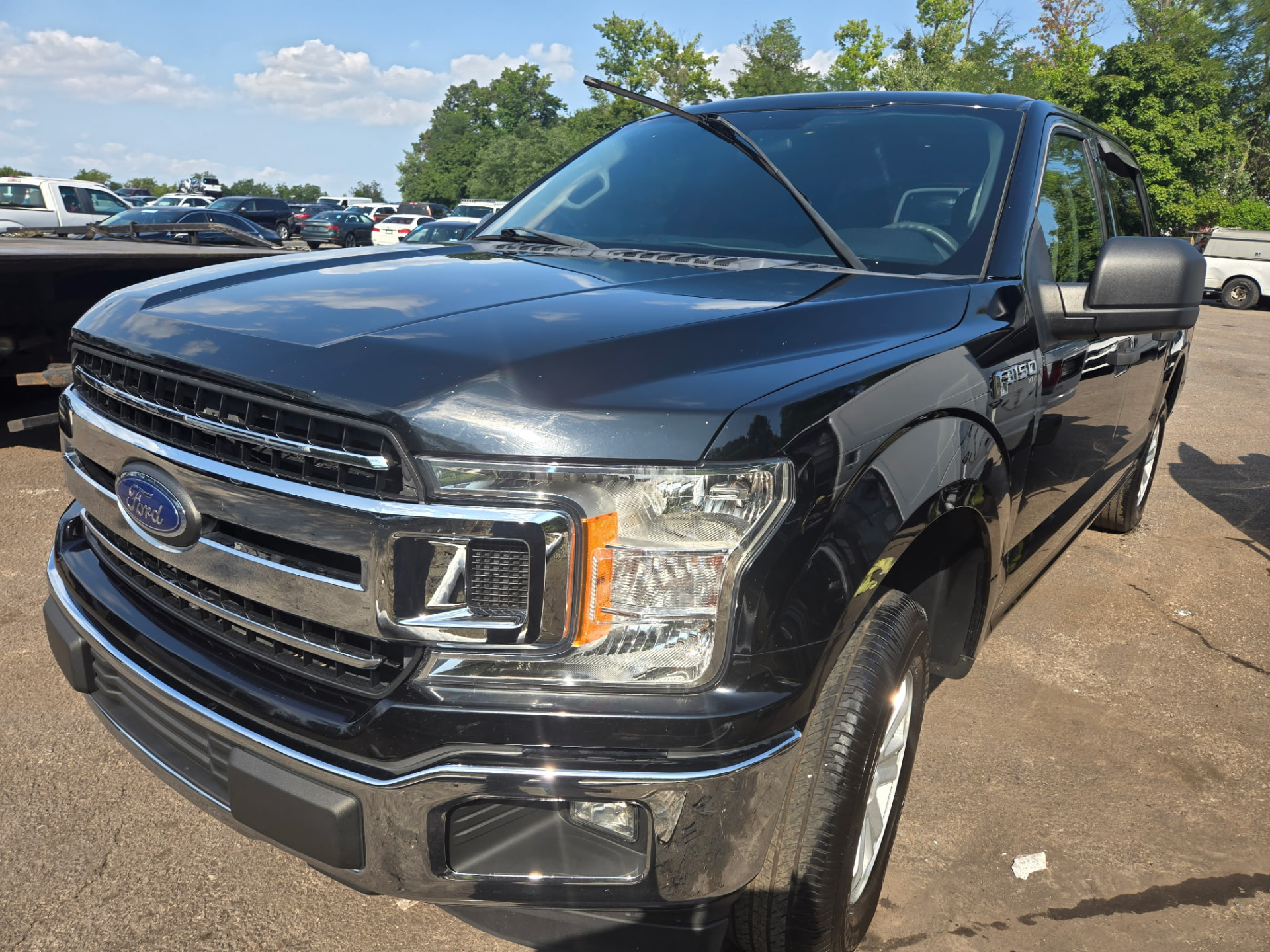Black Ford F-150 truck detailed with polished chrome and clean paint