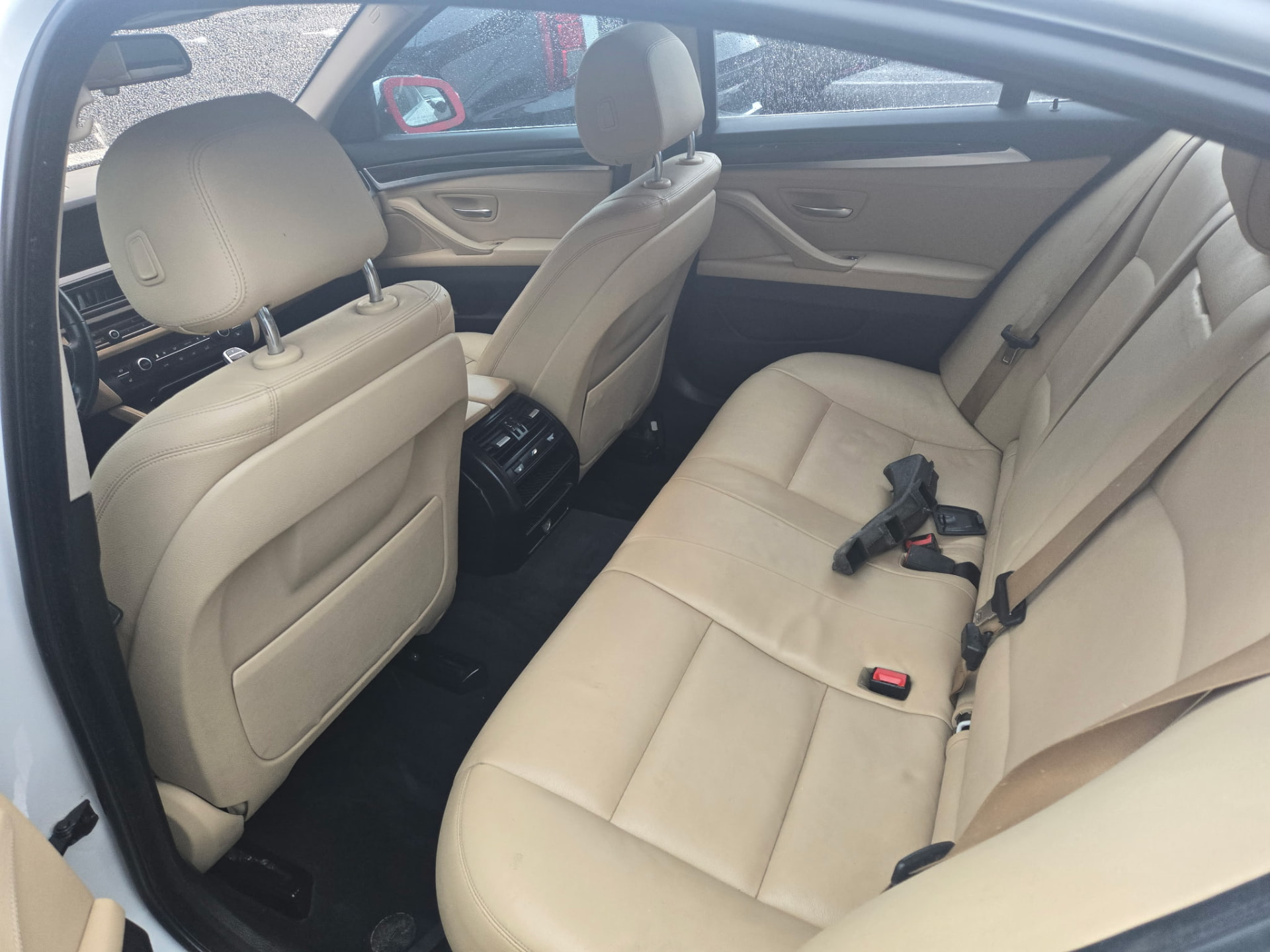 Tan leather rear seats cleaned and conditioned during an interior deep clean